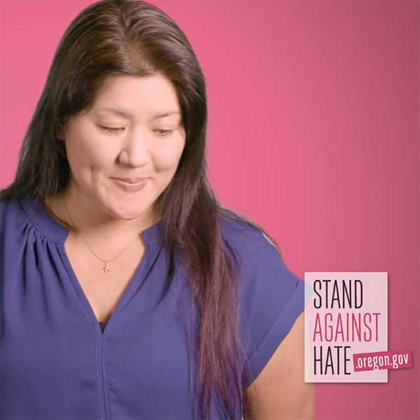Screenshot of a woman speaking, from the Oregon DOJ's Stand Against Hate video