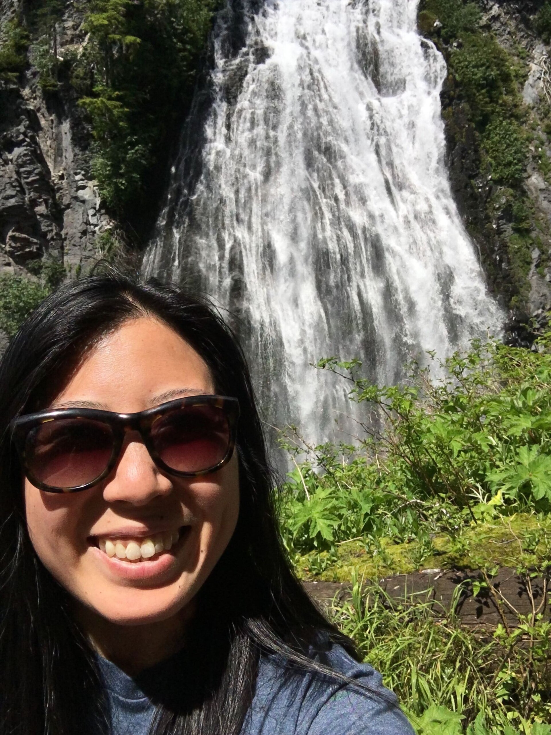 Alexis Wong, Account Manager, in front of a waterfall