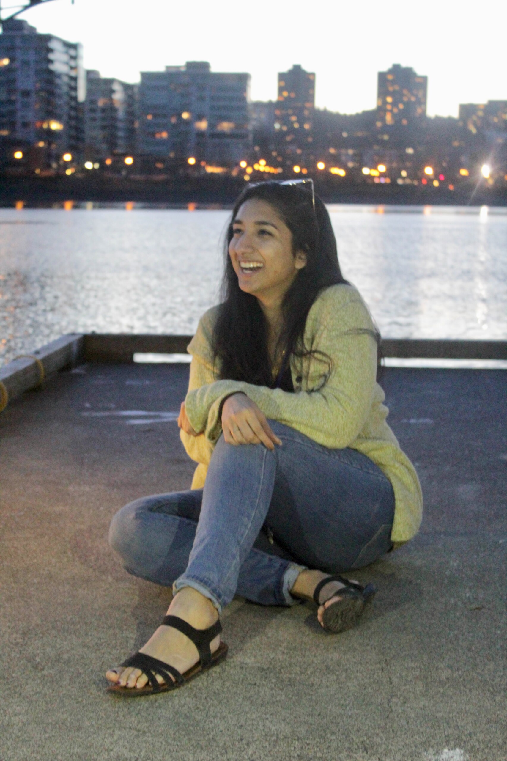 Informal portrait of Naureen Khan at the waterfront.