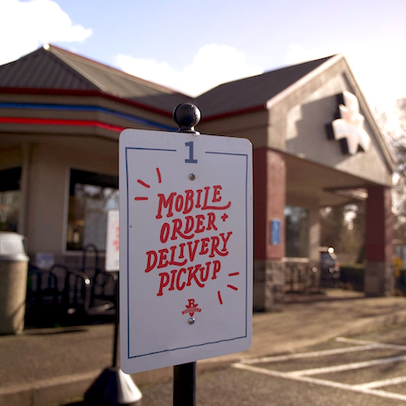 Curbside pick up signs for Burgerville online orders.