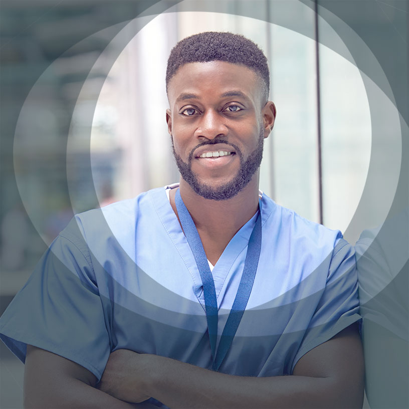 A Black male nurse in scrubs with arms folded, smiling at the camera. An image from the KnowFully website.
