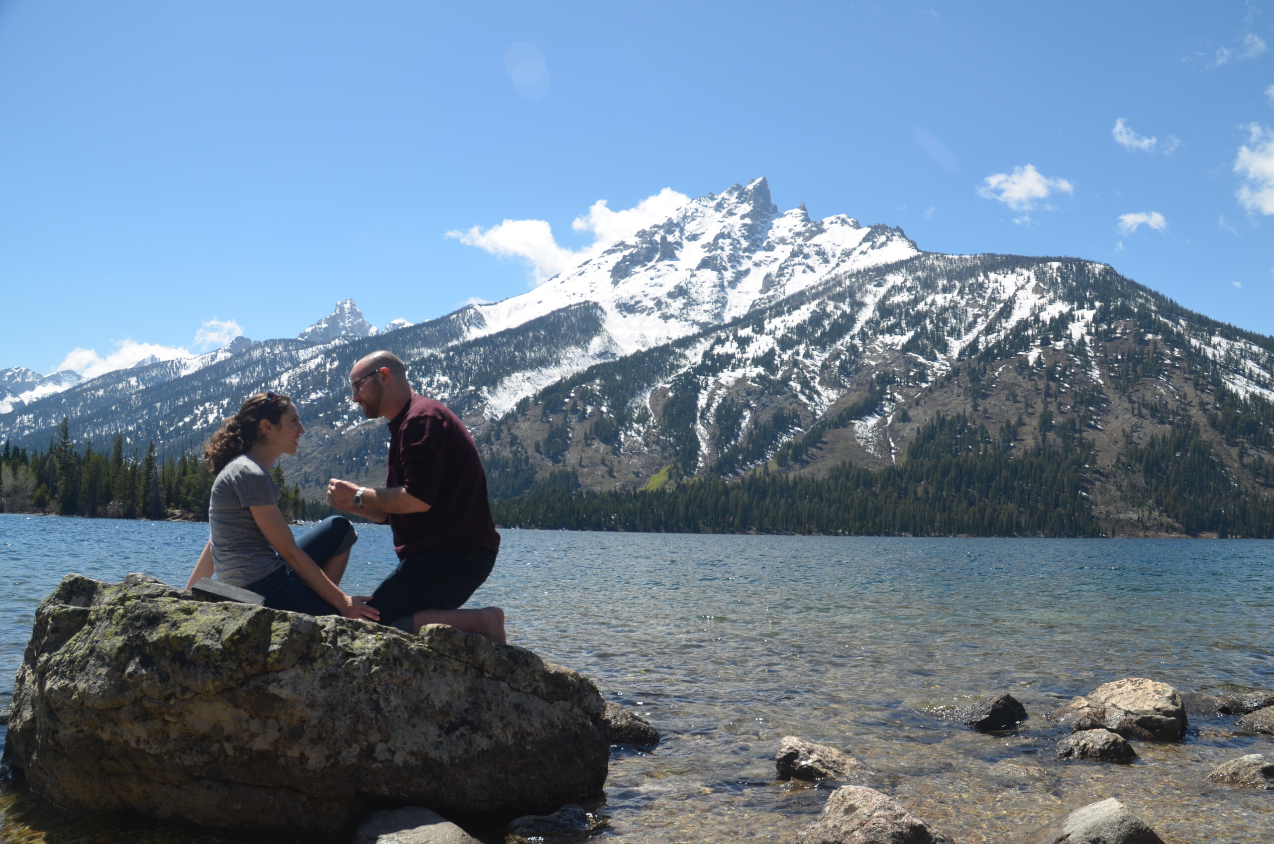 Andrew Thomson and his wife at a lake in front of a snowy mountain.