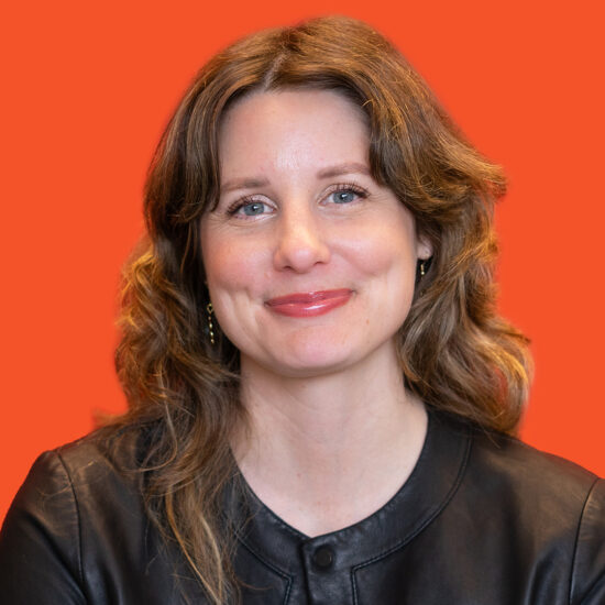 A smiling woman with shoulder-length brown hair.