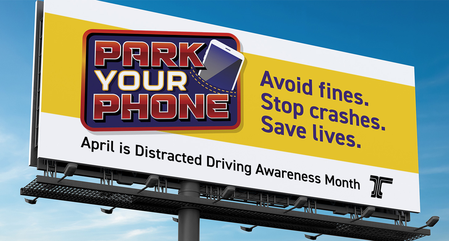 An outdoor billboard of an ODOT "Park Your Phone" public service announcement.