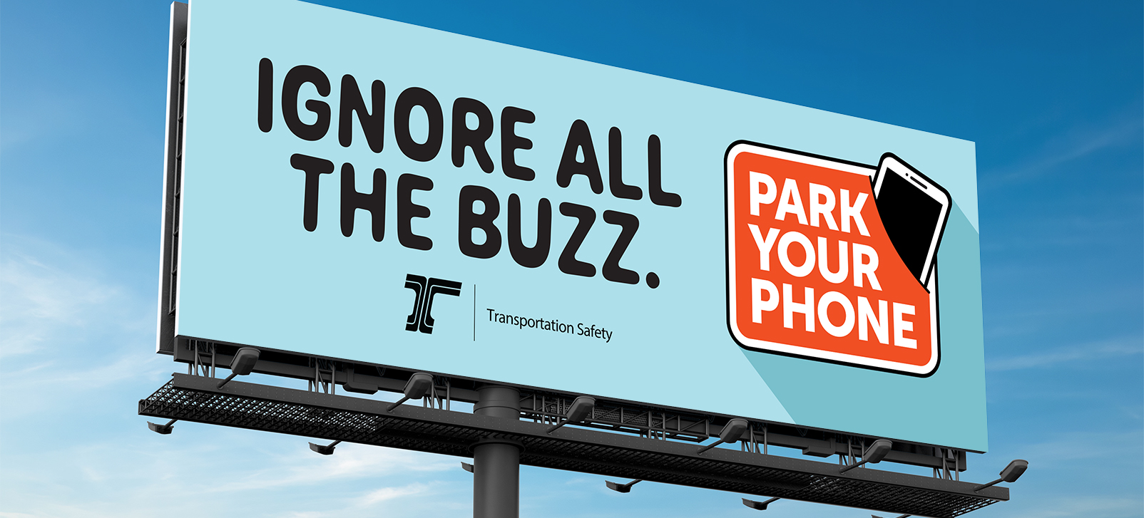 An outdoor vinyl sign of an ODOT “Ignore All The Buzz” public service announcement.