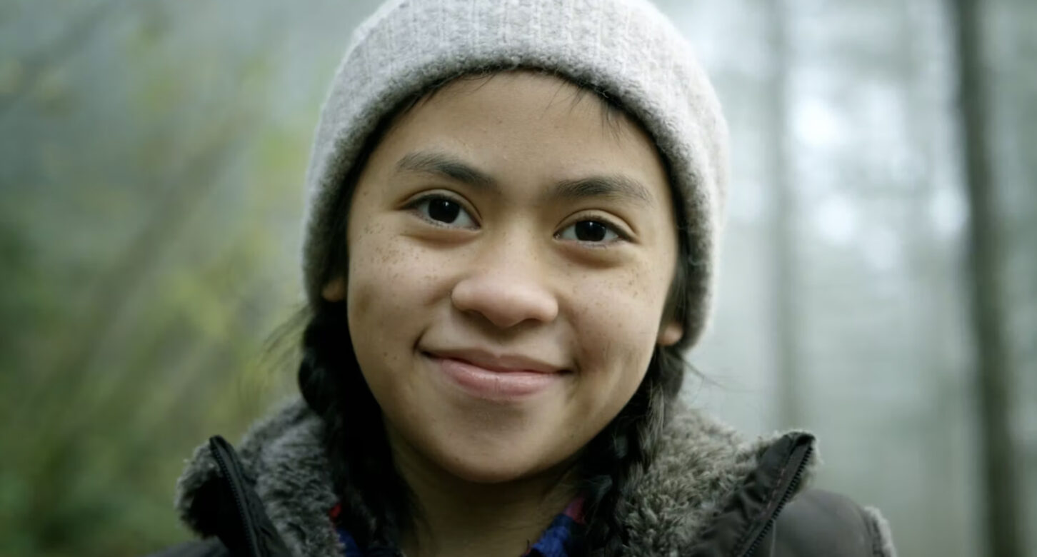 A closeup of a young woman in a forest, from a video for the Oregon Forest Resources Institute.