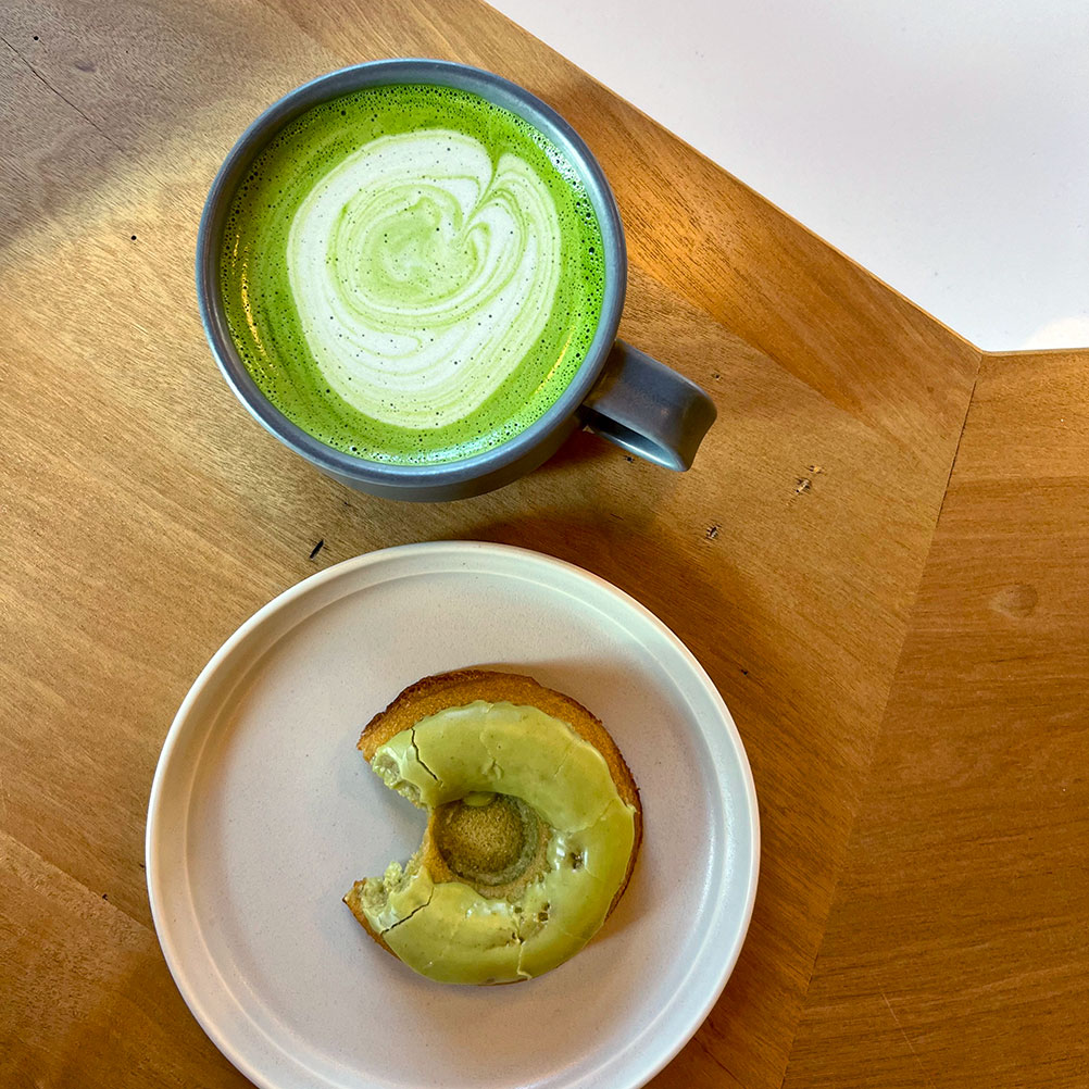 A matcha latte and a matcha donut.