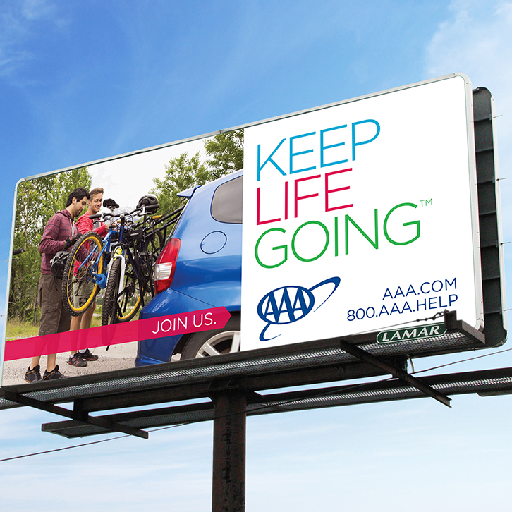 A billboard advertisement featuring the AAA "Keep Life Going" branding.