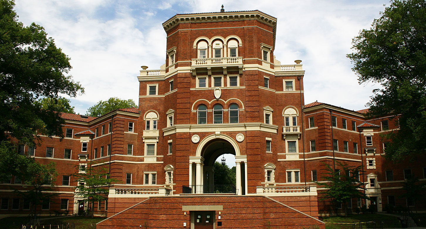 An ornate, multi-story brick building with many arches on the Oregon State University campus.