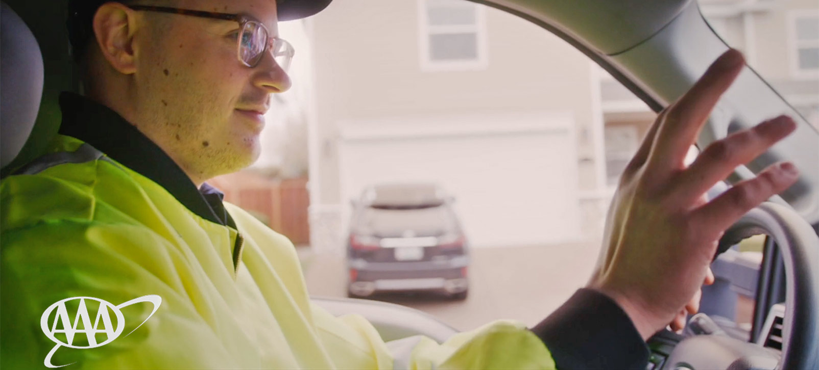 Video still of a AAA employee in a service truck on his way to help a customer.