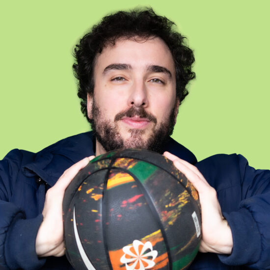 A head shot of Tony Baker holding a basketball.